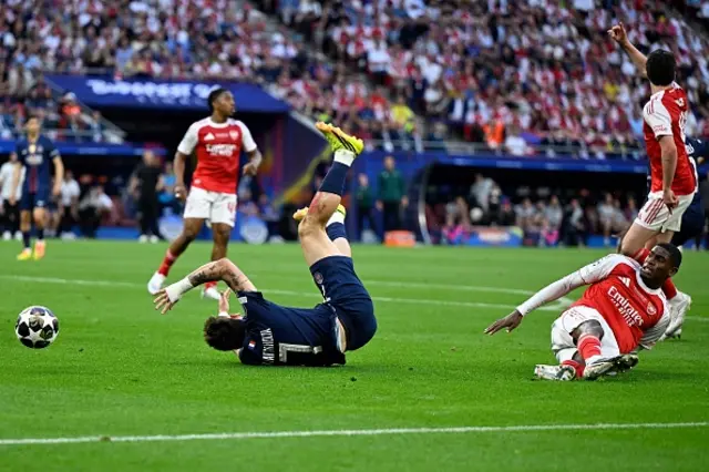 Khvicha Kvaratskhelia (L) falls after a foul by Arsenal's Spanish defender Cristhian Mosquera