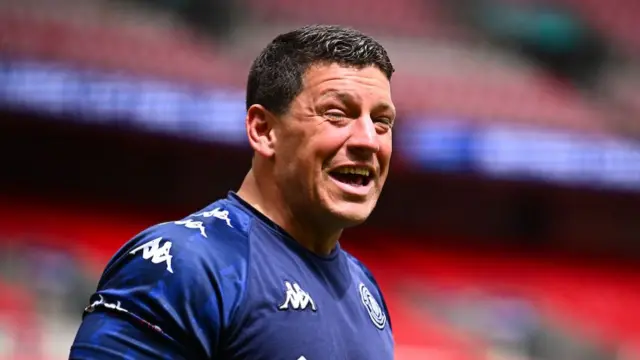 Wigan boss Matt Peet smiling on the pitch at Wembley before his side's Challenge Cup final against Hull KR.