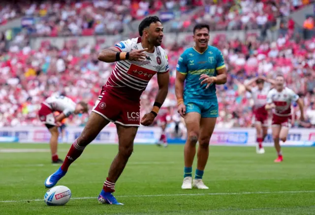 Wigan Warriors' Bevan French (left) celebrates after scoring a try
