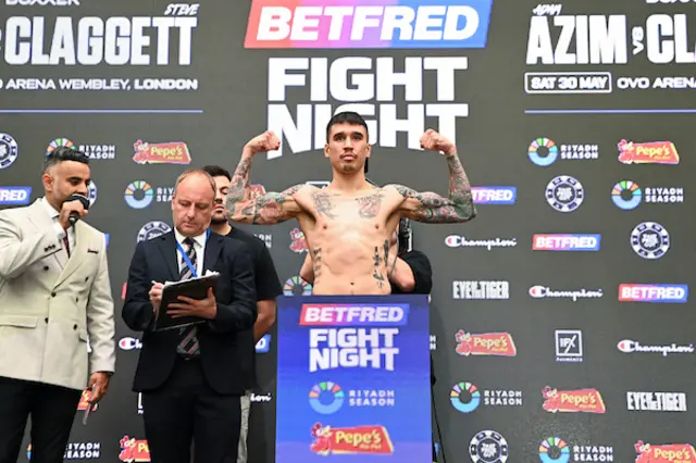 Steve Claggett flexing his biceps on the scales