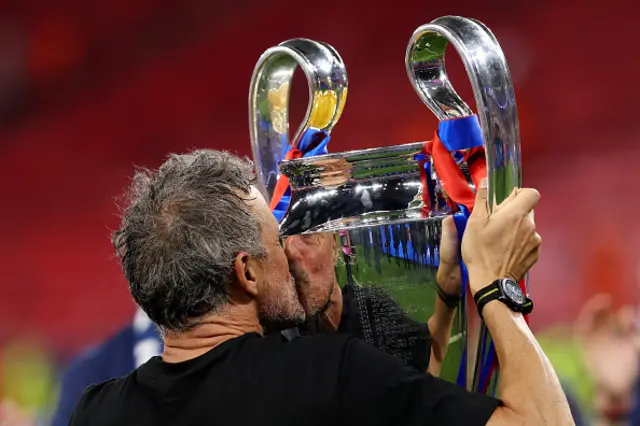 Luis Enrique, Head Coach of Paris Saint-Germain, kisses the UEFA Champions League trophy
