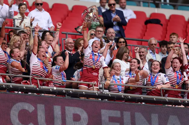 Wigan players lift the Challenge Cup