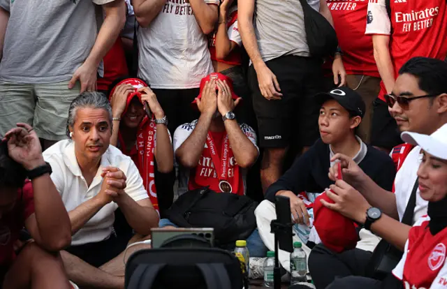 An Arsenal fan reacts to his sides defeat as fans