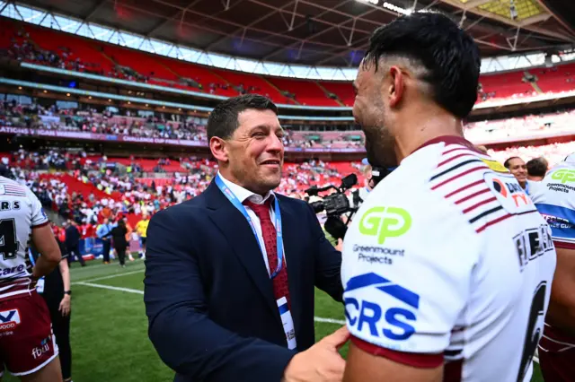 WIgan's coach Matt Peet shakes Bevan French's hands after victory over Hull KR.