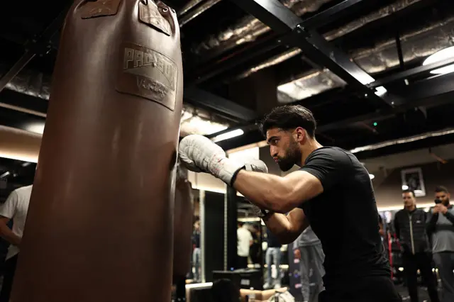 Adam Azim punching the heavy bag