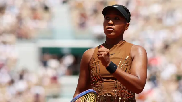 Naomi Osaka celebrates with a clenched fist