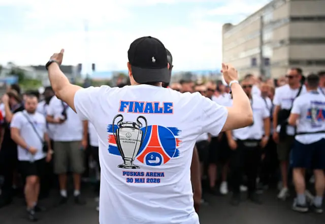 PSG supporters cheer as they march towards the stadium in Budapest