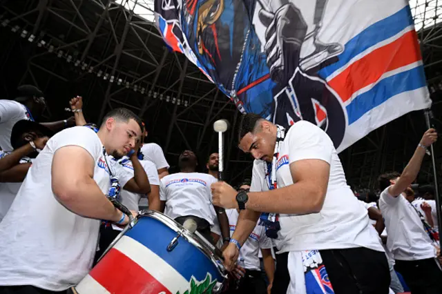 Fans of Paris Saint-Germain are seen with a drum inside the stadium