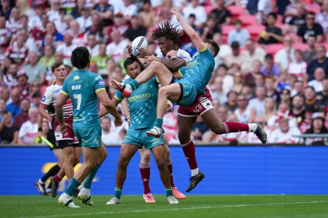 Junior Nsemba of Wigan Warriors gathers the loose ball before scoring a try