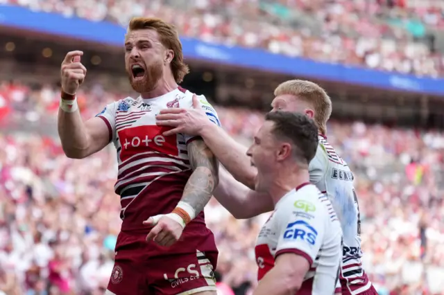 Adam Keighran of Wigan Warriors scores a try