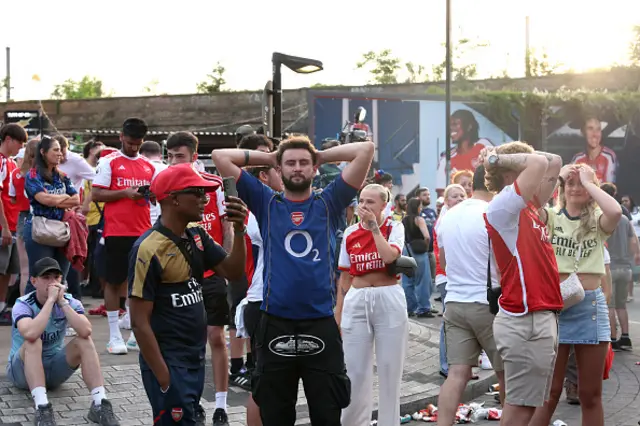 An Arsenal fan reacts to his sides defeat as fans