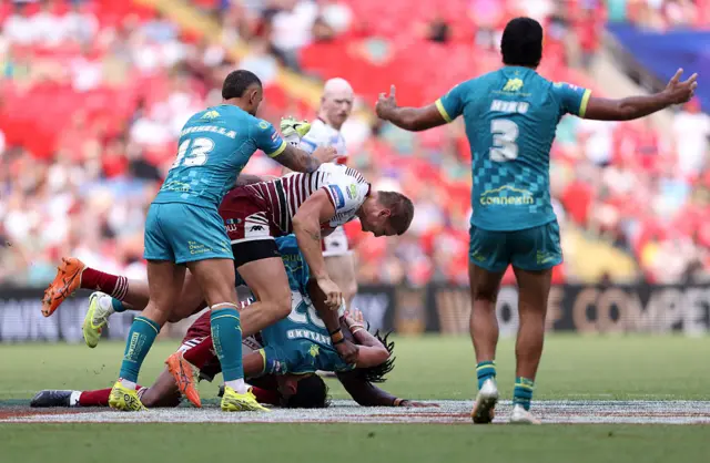 Sam Walters of Wigan Warriors commits a foul which results in a red card