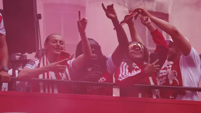Arsenal Women players celebrate on an open-top bus during Arsenal Champions Parade in north London,