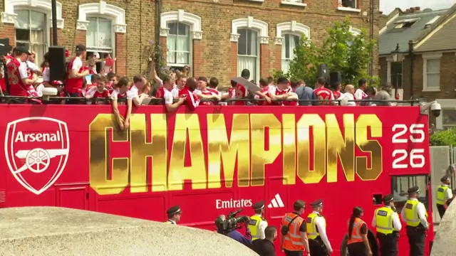 The bus says "champions 26" on it