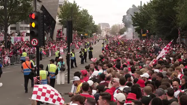 Fans wait further along the route