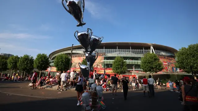 Fans outside Arsenal Stadium on Sunday