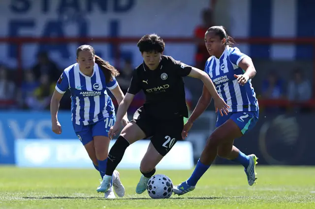 : Aoba Fujino of Manchester City looks to dodge the tackle from Brighton & Hove Albion's Manuela Vanegas during the Barclays Women's Super League match