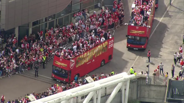 An aerial image of the buses setting off - the trophy can be seen at the front