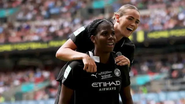Khadija Shaw of Manchester City celebrates scoring her team's first goal with teammate Grace Clinton