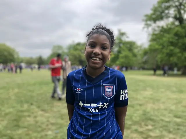 Leela in an Ipswich Town shirt.