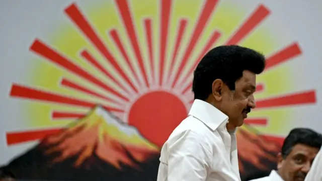 Chief Minister of India's Tamil Nadu state and Dravida Munnetra Kazhagam (DMK) party president MK Stalin (L) walks past the party symbol after releasing their manifesto ahead of India's upcoming national elections in Chennai on March 20, 2024
