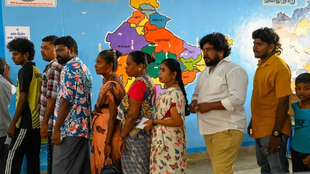 Voters queue to cast their votes outside a polling station during the Tamil Nadu Legislative Assembly elections in Chennai, India, on April 23, 2026.