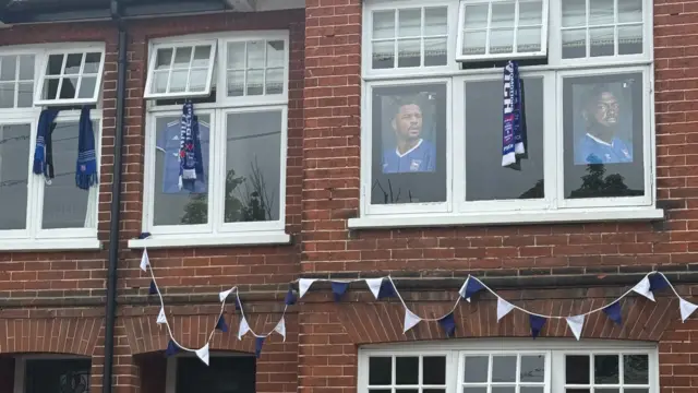 House decced out in bunting and posters of Ipswich Town players