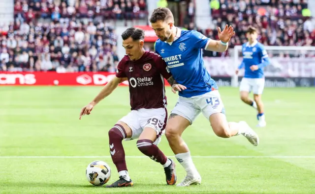 Alexandros Kyziridis battles with Nicolas Raskin for possession
