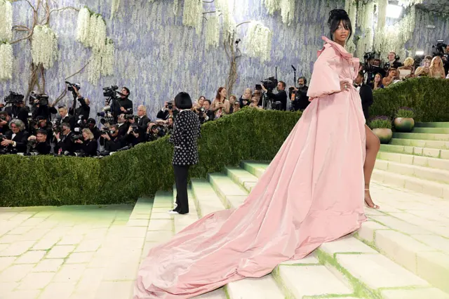 WNBA player Angel Reese wears a long, pink gown