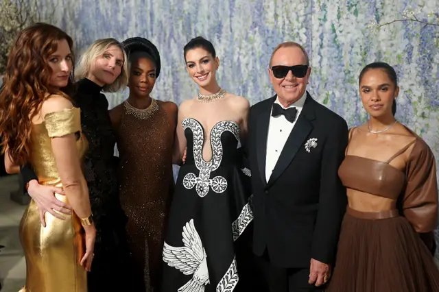 esigner Michael Kors posing with stars