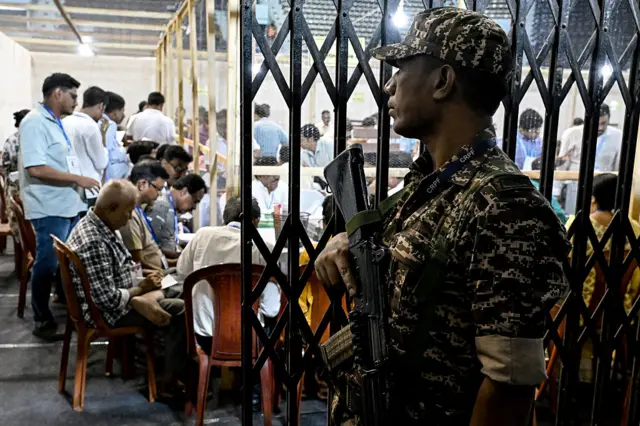 A Central Reserve Police Force (CRPF) personnel stands guard as election officials count votes after the West Bengal Legislative Assembly elections at the Netaji Indoor Stadium in Kolkata on May 4, 2026. Vote counting in key Indian state elections were underway on May 4 under tight security, with the focus on West Bengal, where Prime Minister Narendra Modi's party is hoping for crucial gains. (Photo by Dibyangshu SARKAR / AFP via Getty Images)