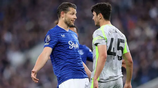 James Tarkowski of Everton clashes with Abdukodir Khusanov