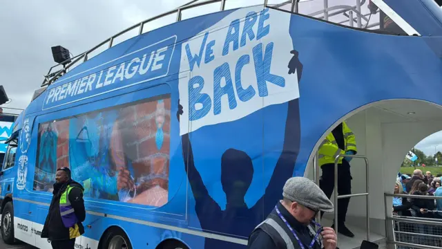 A bus with "we are back" painted on the side