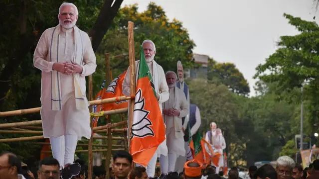 A large cutout of Narendra Modi is displayed during a roadshow ahead of the second phase of the assembly election in Kolkata, India, on April 26, 2026