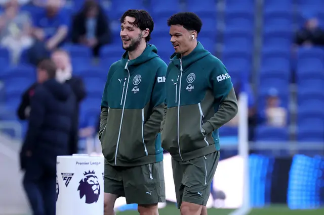 Manchester City players inspect pitch