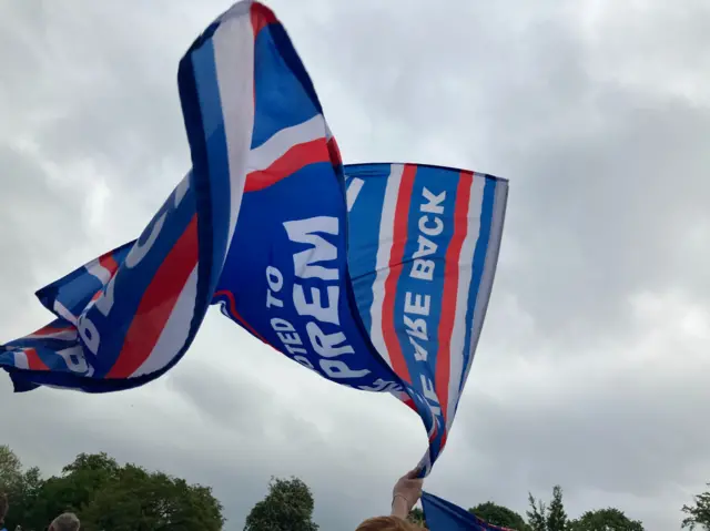 An Ipswich Town flag is waved in the air