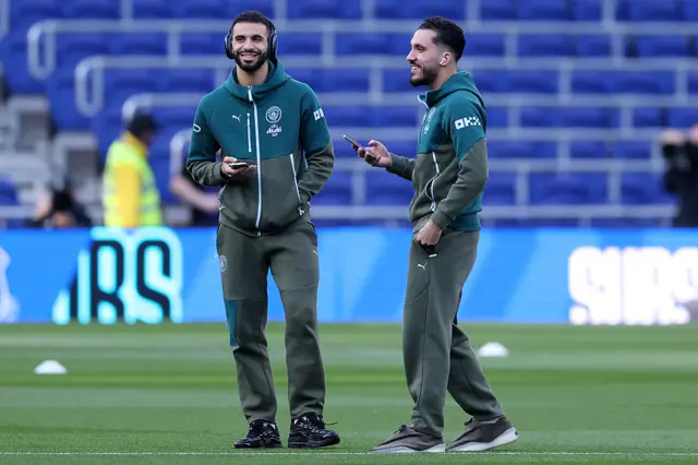 Manchester City players inspect pitch