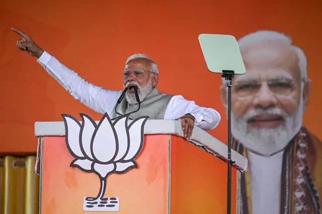 India's Prime Minister and Bharatiya Janata Party (BJP) leader Narendra Modi addresses his supporters during a mass rally in Kolkata on March 14, 2026