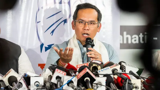 Congress leader Gaurav Gogoi, wearing a grey kurta and while stole, speaks on a mic, addressing a press conference in Assam's Guwahati city in February 2026.