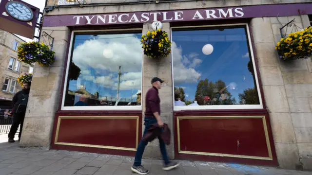 Fan walks past Tynecastle Arms pub