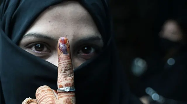 A voter shows her inked finger after casting her ballot during the second and final phase of West Bengal Legislative Assembly elections in Kolkata on 29 April.