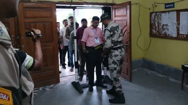Security personnel checking officials at a counting centre in Bengal