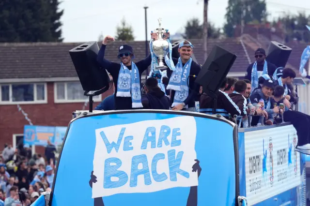 Coventry City's Josh Eccles (left) and goalkeeper Carl Rushworth with the Sky Beat Championship trophy during a victory parade in Coventry