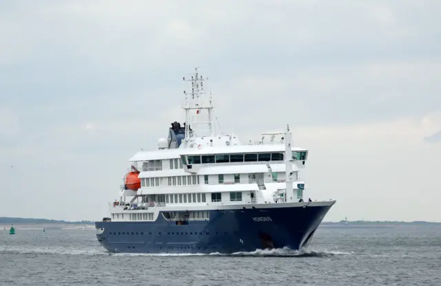 Small cruise ship sailing in water