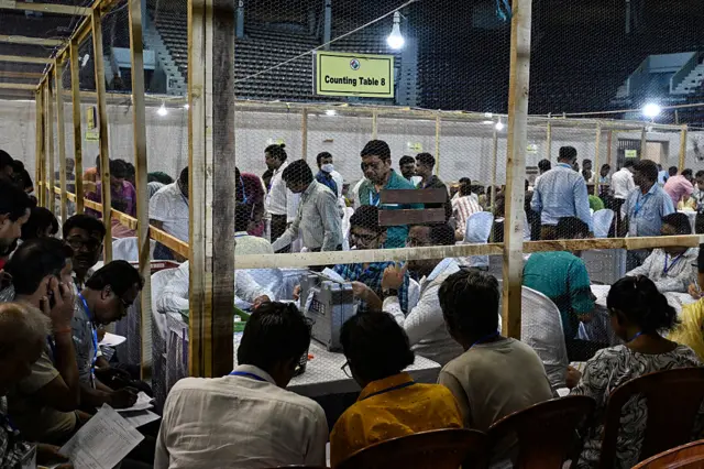 Election officials count votes after the West Bengal Legislative Assembly elections at the Netaji Indoor Stadium in Kolkata on May 4, 2026. Vote counting in key Indian state elections were underway on May 4 under tight security, with the focus on West Bengal, where Prime Minister Narendra Modi's party is hoping for crucial gains. (Photo by Dibyangshu SARKAR / AFP via Getty Images)