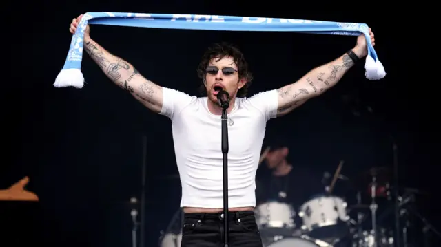 Tom Grennan performs during a victory parade in Coventry