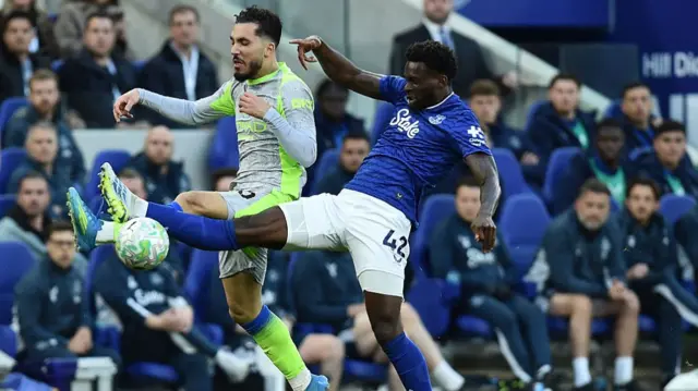 Rayan Cherki and Tim Iroegbunam battle for the ball