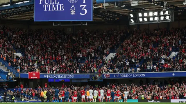 Nottingham Forest players celebrate with away fans