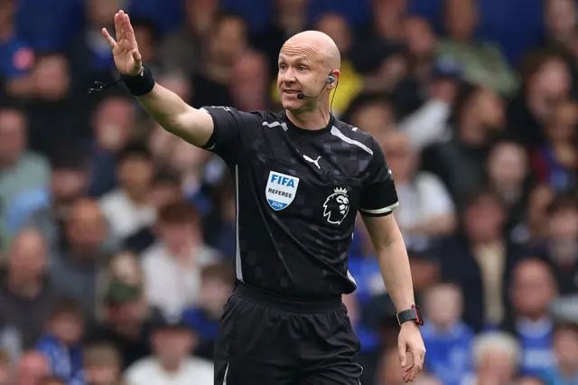 Referee Anthony Taylor gestures