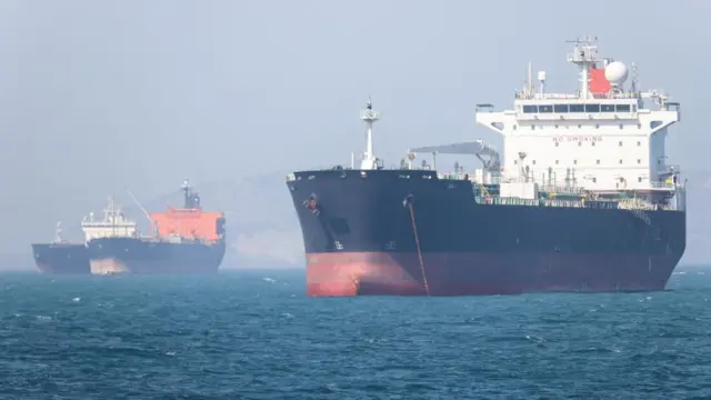 Two large ships in the strait of hormuz.